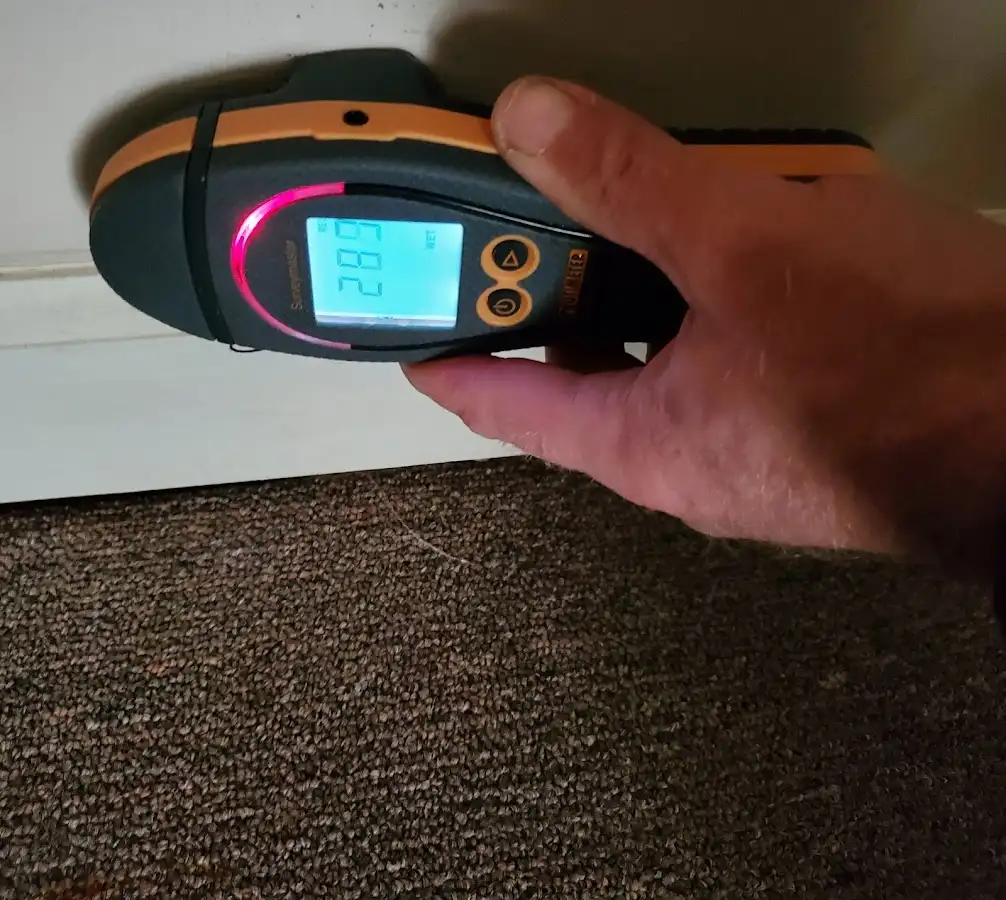 Moisture detection at baseboard during Storm Damage Restoration in Tontitown